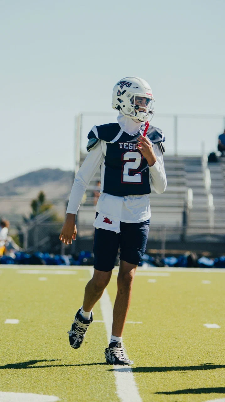 Jayden Hansen walking on the field in his navy Tesoro number 2 uniform — 2025 freshman season