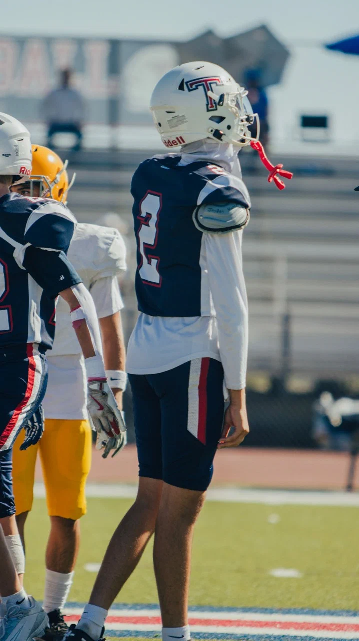 Rear three-quarter view of Jayden Hansen wearing number 2 among players on the field — 2025 freshman season