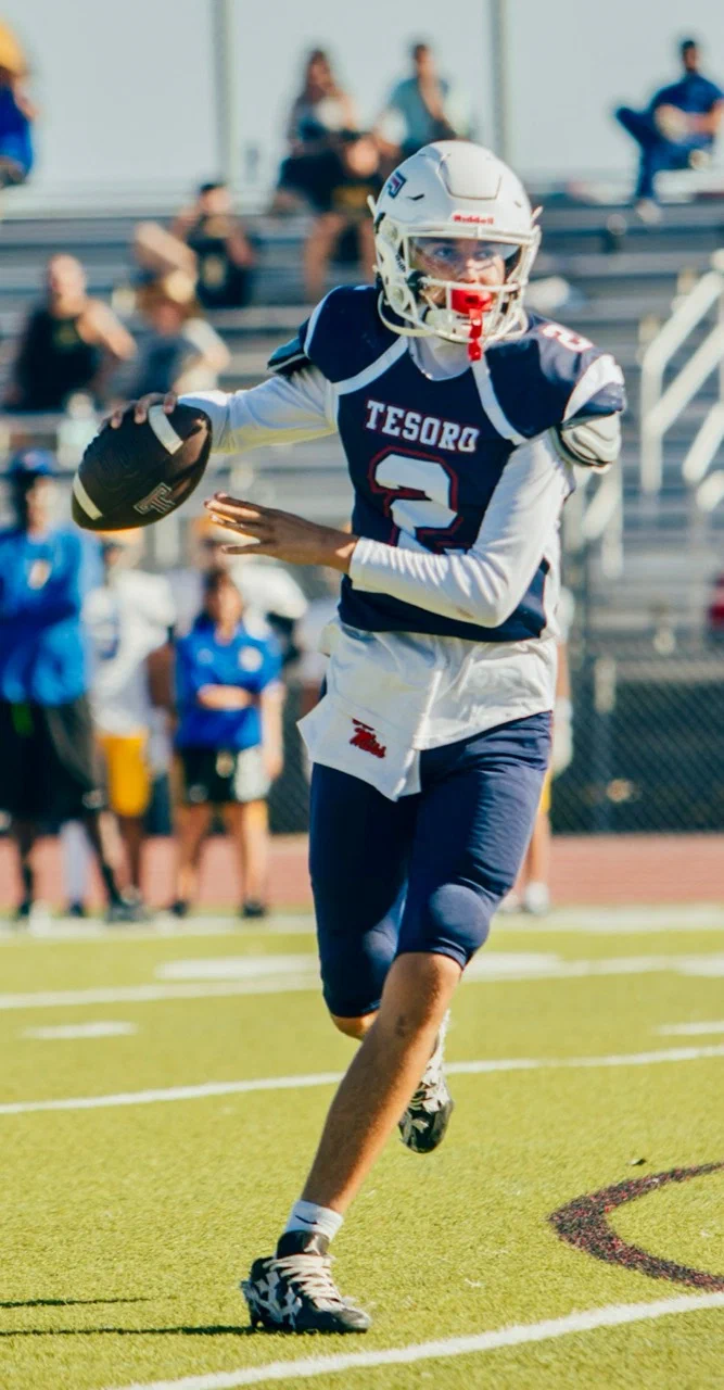 Jayden Hansen moving with the football in his navy Tesoro number 2 uniform — 2025 freshman season