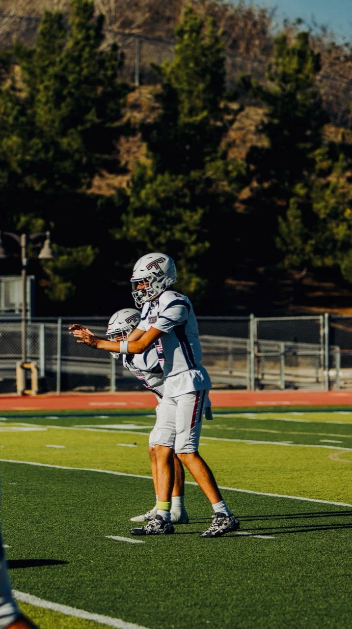 Jayden Hansen in Tesoro’s light-colored uniform with his hands extended in front of him — 2025 freshman season